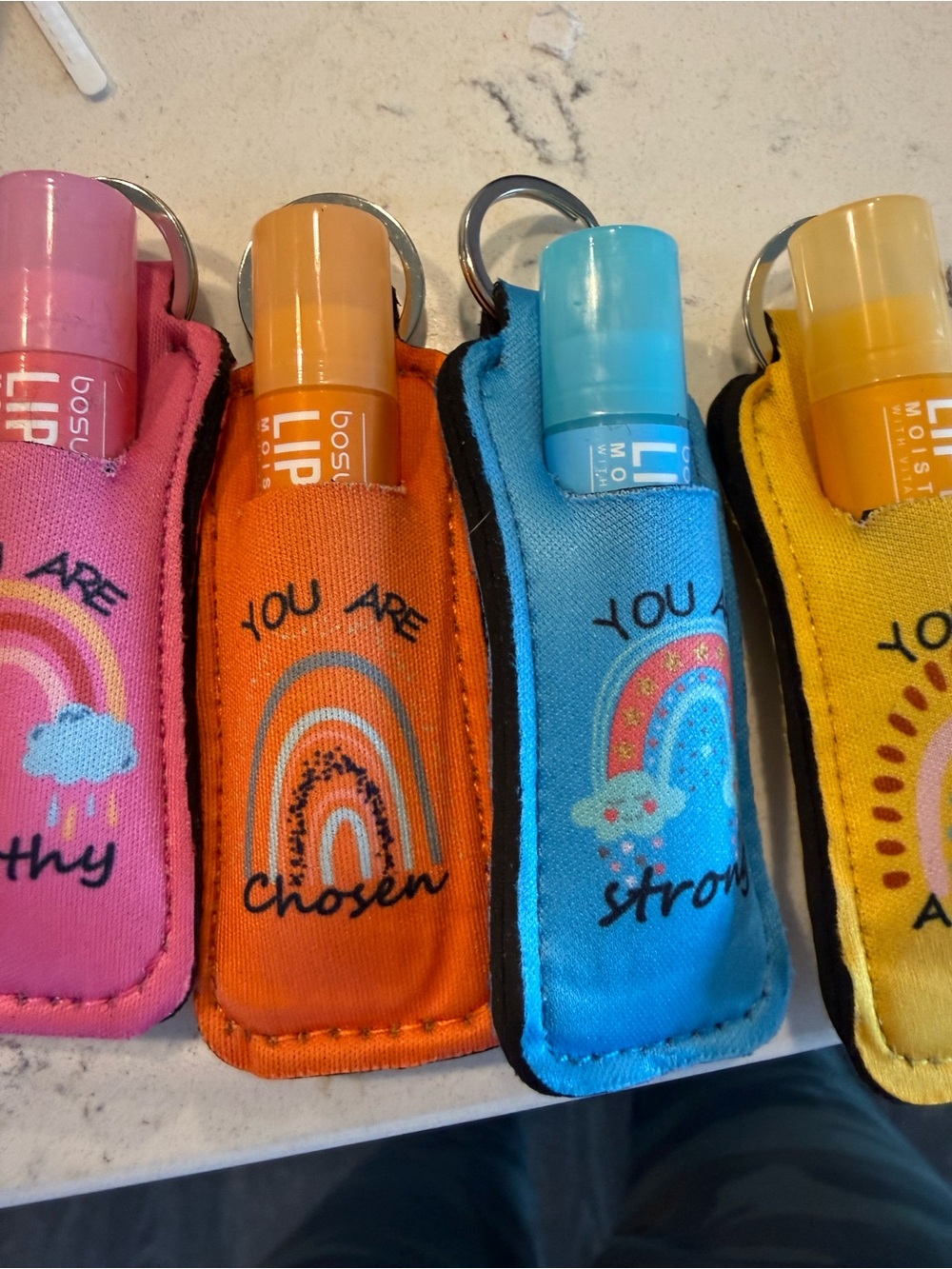 Flavored Lip balm inside a key ring neoprene positive sentiment